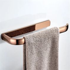 a towel rack with two towels hanging from it's sides and a towel on the other side