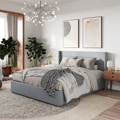 a bedroom with a large bed and potted plants