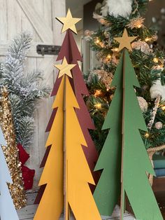 three wooden christmas trees sitting next to each other