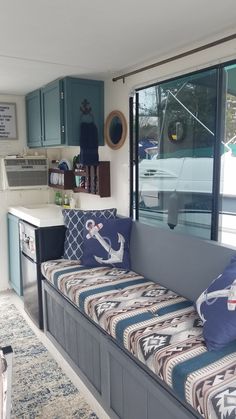 a living room filled with furniture and lots of windows