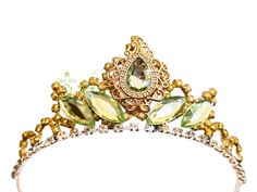 a gold tiara with green leaves on it