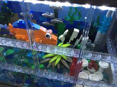 an aquarium filled with lots of different types of legos and other things in it