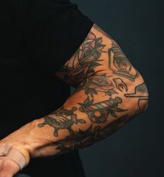 a man with tattoos on his arm and arms