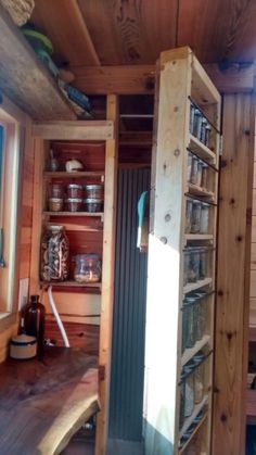 the inside of a tiny cabin with shelves and drawers