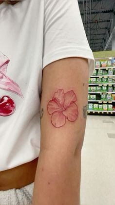 a woman with a flower tattoo on her arm