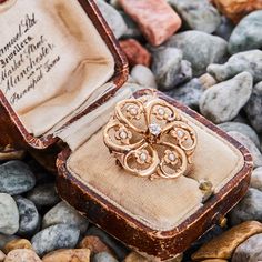 This pretty vintage seed pearl and diamond brooch is in the shape of a circle and is centered with an Old Mine cut diamond. The openwork of the gold is set with seed pearls. The brooch pin is crafted in 10k yellow gold with a fantastic patina. Old Mine Cut Diamond, Diamond Brooch, Edwardian Era, European Cut Diamonds, Seed Pearl, Art Deco Era, Pearl Diamond, Brooch Pin, Diamond Cuts