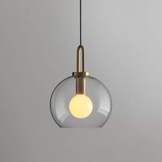 a glass light hanging from a ceiling fixture