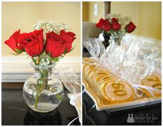 red roses are in a vase with white flowers and cookies on a tray next to each other