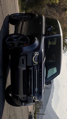 the back end of a black truck parked on top of snow covered ground