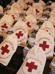 an image of some red crosses on the back of small bottles with wine in them