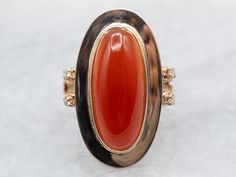 This gleaming yellow-gold bezel set ring is perfect for adding sparkle and sass to your everyday look. Featuring a vibrant oval cut carnelian center and diamond accents, this ring is both eye-catching and stylish! Slip it on for a little extra pizzazz! Metal: 14K Yellow Gold Gem: Carnelian Gem Measurements: 8.1 x 18.9 mm, Oval Accents: 4 Diamonds totaling .06 Carats, SI-I in Clarity, H in Color Ring Size: 4.50 Marks: "14K" Stamped on the inside band SKU #: A36090 Each piece has been identified and graded by a Graduate Gemologist who has been certified by the Gemological Institute of America (GIA). We have six brick-and-mortar storefronts in Maine, Massachusetts, and New Hampshire and have been in business for over 25 years! Please visit our Shop's About Page or our website for more informa Carnelian Jewelry, Bezel Set Ring, Carnelian Ring, Ring With Diamond, Cabochon Ring, Cabochon Jewelry, Set Ring, Gold Gift, Color Ring