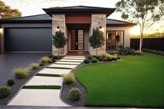 a modern house with landscaping in the front yard and driveway leading up to it's entrance