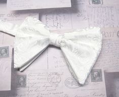 "Beautiful pre-tied, adjustable double tiered banded bow tie.  It will adjust from 13\" through 20\" neck. Bow dimensions 3.25\" x 4.5\"." White Adjustable Bow Tie Back, Adjustable White Bow Tie Back, Adjustable White Bow Tie With Decorative Bow, Elegant Spring Bow Tie Back Ties, White Adjustable Standard Bow Tie, Adjustable Detachable White Bow, Elegant Pre-tied Adjustable Bow Tie, Adjustable White Bow For Black Tie Occasion, Classic Adjustable Bow With Detachable Feature