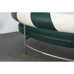 a green and white bench with metal legs