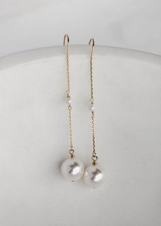 Cecile is a dainty set of pearl drop earrings featuring light-catching Swarovski pearl drops suspended from a fine chain. These delicate details whisper sophistication and style which you will love to wear after your wedding day. * DETAILS * > Designed and handmade in Australia. Worldwide shipping > Swarovski pearls, gold or silver plated settings > Measurement: 65mm * READY TO SHIP * The Cecile earrings are ready to ship. Please allow 5-7 business days for processing plus delivery time Delicate Pearl Drop Linear Earrings, Delicate Long Drop Linear Earrings With Pearl Charm, Pearl White Dangle Earrings With Pearl Chain, Elegant Long Drop Pearl Earrings With Pearl Charm, Delicate Long Drop Pearl Earrings For Formal Occasions, Elegant Long Drop Pearl Pendant Earrings, Minimalist Pearl Linear Earrings For Formal Occasions, Akoya Pearl Drop Dangle Earrings, Minimalist Pearl Chain Earrings For Formal Events