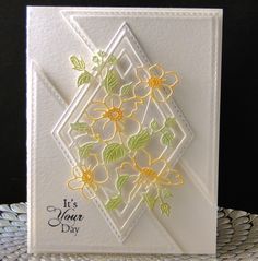 a white card with yellow flowers on it