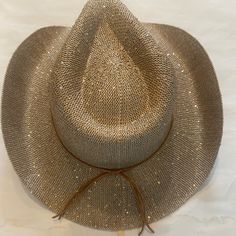 23.5" Crown; 3.5" Brim. Micro Mini Sparkles On Cowboy Hat. Tie Around Brim Wrap As Accent Color: Beige With Gold Accents & Dark Tan Trim. Gold Country Style Hat For Rodeo, Gold Fedora Hat For Rodeo, Gold Fedora Western Hat, Luxury Gold Western Hat, Country-style Gold Hat For Rodeo, Tan Trim, Anthropologie Accessories, Rancher Hat, Dark Tan