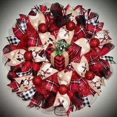 a christmas wreath with red, white and black decorations