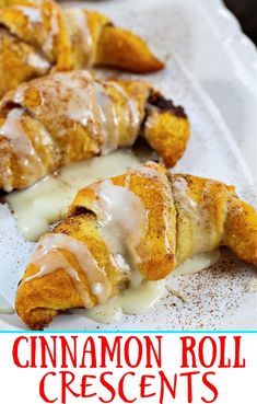 cinnamon roll crescents with icing on a white plate