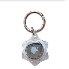 a bottle cap keychain with a glass star on the front and back side