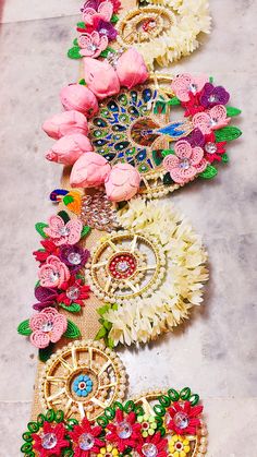 several different types of flowers are lined up on the floor with beads and sequins