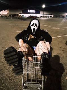 a person sitting in a shopping cart wearing a mask