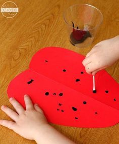 someone is making a paper boat out of watermelon slices with toothpicks