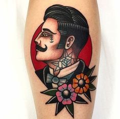 a man with a mustache and flower tattoo on his leg