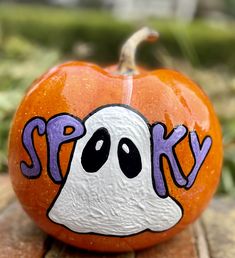 a painted pumpkin with the word spook on it