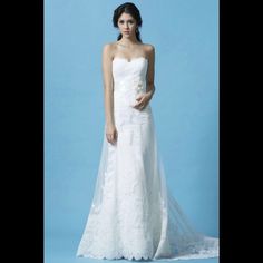 a woman in a white wedding dress posing for a photo with her hand on her hip