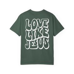 Comfort Colors Love Like Jesus Shirt Embrace faith-inspired comfort and style with our Comfort Colors Love Like Jesus Shirt. This shirt beautifully combines a simple design with unmatched comfort, allowing you to wear your faith proudly while enjoying a soft, relaxed fit. Key Features: Premium Comfort Colors Fabric: Crafted from the renowned Comfort Colors fabric, this shirt offers superior softness, durability, and a vintage, lived-in feel that ensures comfort with every wear. Inspirational Des Simple Christian Shirt Designs, Cotton T-shirt With Faith Text Print, Inspirational Relaxed Fit Tops For Streetwear, Green Graphic Tee With Lettering, Relaxed Fit Inspirational Shirt With Graphic Print, Green Cotton T-shirt With Lettering, Inspirational Relaxed Fit Shirt With Graphic Print, Inspirational Graphic Print Shirt With Relaxed Fit, Inspirational Slogan Tops With Relaxed Fit