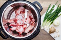 raw meat in an instant pot with onions and celery