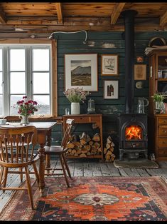 a living room filled with furniture and a fire place next to a wooden table on top of a rug