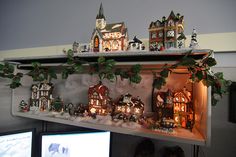 a shelf with christmas decorations on top of it