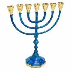 a blue and gold menorah with five candles on it's stand, in front of a white background