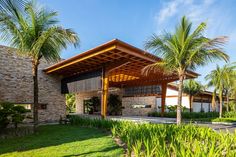 a building with palm trees in front of it and a walkway leading to the entrance