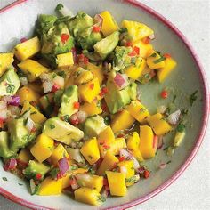 a bowl filled with fruit and vegetables on top of a table