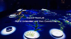 a group of white vases with plants in them on a blue lit floor that reads, espace teamlab world unleashed and then connecting