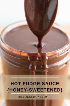 hot fudge sauce / honey - sweetened in a glass jar with a spoon