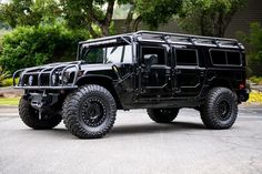 a black hummer truck parked in a parking lot