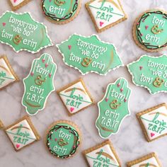 decorated cookies are arranged on a table with the names of each event and date written on them