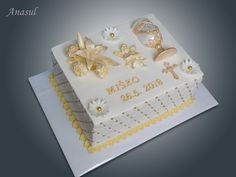 a white cake with gold decorations on it