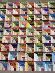 a very large quilt made with many different colors and patterns on the front, back and sides