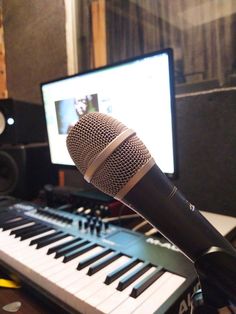 a microphone sitting on top of a keyboard