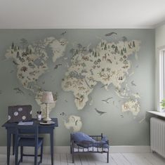 a room with a desk, chair and map on the wall