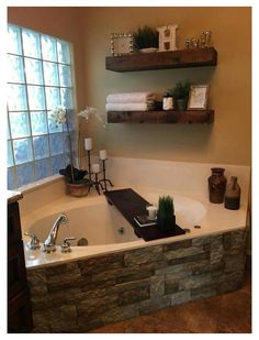 a bathroom with a stone bathtub and two shelves above the tub that have towels on it