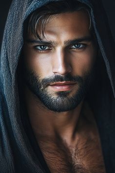 a shirtless man with blue eyes and a hood on his head is looking at the camera