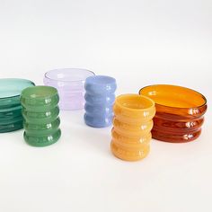 several different colored glass bowls sitting next to each other