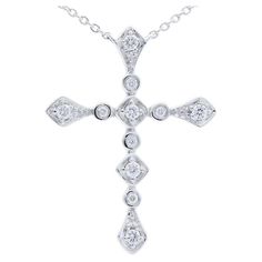 Diamond Carat Weight: This exquisite cross necklace boasts a total of 0.12 carats of diamonds. Adorned with 11 meticulously chosen round-cut diamonds, the necklace exudes a delicate brilliance and timeless charm. Gold Type: Crafted with precision in 14K white gold, the necklace embodies a perfect fusion of sophistication and purity. The white gold setting not only enhances the diamonds' radiance but also adds a contemporary touch to the classic cross design. Setting Style: The diamonds are elegantly cradled in bezel settings. This setting style offers a sleek and modern look, securely holding each diamond in place while creating a smooth and seamless appearance. The bezel setting is known for its protective and minimalist design. Gross Weight: Weighing a stylish 2.6 grams, the necklace str Luxury Diamond Cross Necklace With Diamond Accents, Cross-shaped Diamond Necklace With Single Cut Diamonds, Diamond White Cross Pendant Necklace With Brilliant Cut, Diamond White Cross Necklace With Single Cut Diamonds, Brilliant Cut Cross Diamond Necklace, Diamond Cross Necklace With Single Cut Diamonds, Brilliant Cut Diamond Cross Necklace, Diamond Necklace With Vvs Clarity Cross Pendant, Classic Diamond Cross Necklace For Formal Occasions