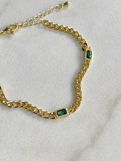 24k gold plated Emerald Green CZ Curb Chain Bracelet. Measures 7” with a 2” extender. We recommend keeping it away from any beauty products or water to preserve it's look. Curb Chain Bracelet, Emerald Bracelet, Emerald Stone, Curb Chain, Stone Bracelet, Chain Bracelet, Emerald Green, Blue Sapphire, Sale Items